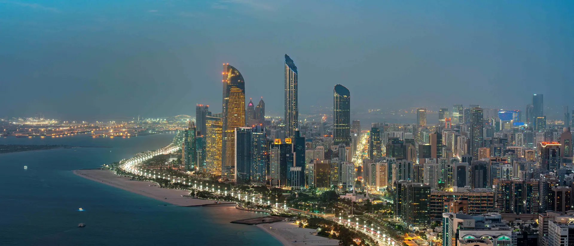 Abu Dhabi Corniche waterfront and illuminated skyline at dusk